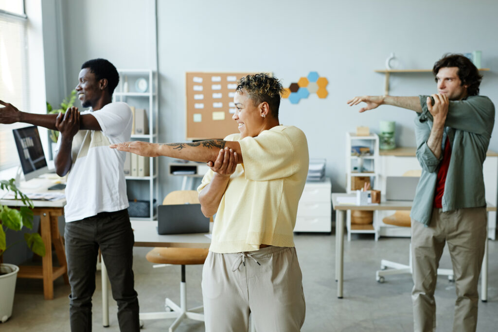 Diverse group of workers exercising together